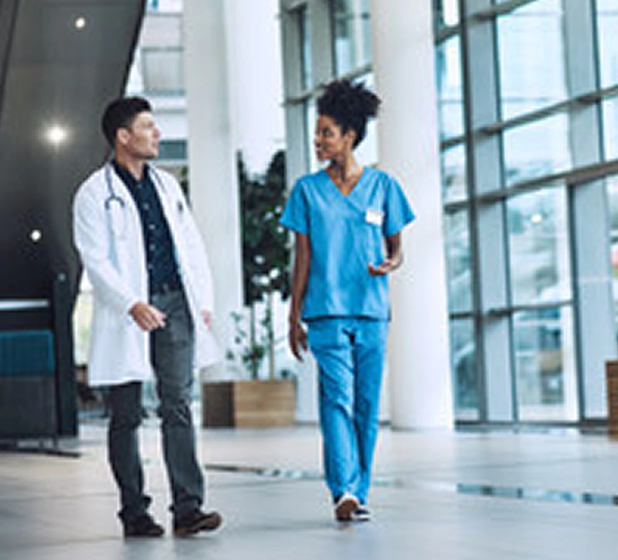 Nurse with Doctor wlaking through hospital