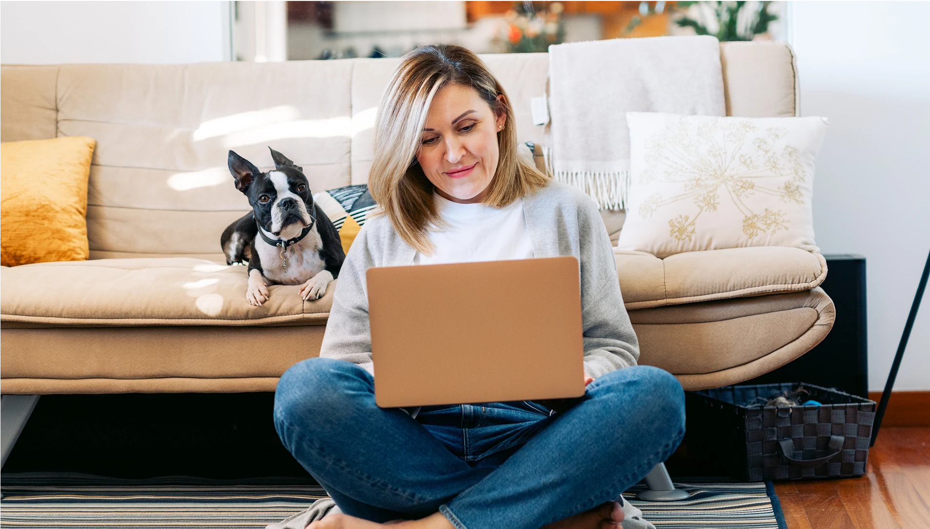 Woman with dog looking at computer